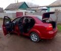 Красный Шевроле Авео, объемом двигателя 1.6 л и пробегом 244 тыс. км за 3300 $, фото 1 на Automoto.ua