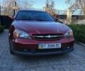 Красный Шевроле Эванда, объемом двигателя 2 л и пробегом 177 тыс. км за 4000 $, фото 1 на Automoto.ua