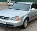 Сірий Шевроле Еванда, об'ємом двигуна 2 л та пробігом 238 тис. км за 1999 $, фото 1 на Automoto.ua
