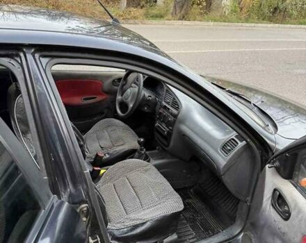 Черный Дэу Ланос, объемом двигателя 1.5 л и пробегом 100 тыс. км за 900 $, фото 2 на Automoto.ua