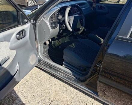 Черный Дэу Ланос, объемом двигателя 1.6 л и пробегом 271 тыс. км за 2000 $, фото 1 на Automoto.ua