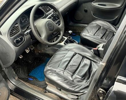 Черный Дэу Ланос, объемом двигателя 1.4 л и пробегом 202 тыс. км за 1400 $, фото 5 на Automoto.ua