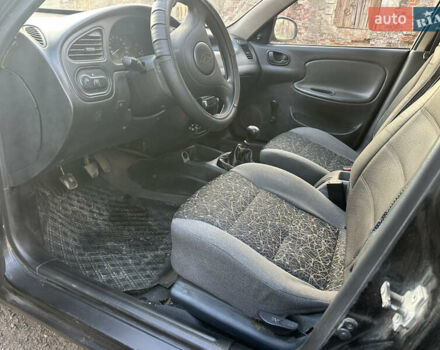 Черный Дэу Ланос, объемом двигателя 1.4 л и пробегом 220 тыс. км за 1450 $, фото 7 на Automoto.ua