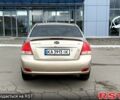 Бежевый Киа Черато, объемом двигателя 2 л и пробегом 255 тыс. км за 3700 $, фото 1 на Automoto.ua