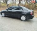 Черный Киа Черато, объемом двигателя 1.6 л и пробегом 280 тыс. км за 2999 $, фото 1 на Automoto.ua