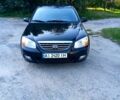 Чорний Кіа Черато, об'ємом двигуна 2 л та пробігом 203 тис. км за 5500 $, фото 1 на Automoto.ua