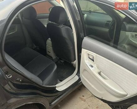 Черный Киа Черато, объемом двигателя 1.6 л и пробегом 230 тыс. км за 4950 $, фото 8 на Automoto.ua