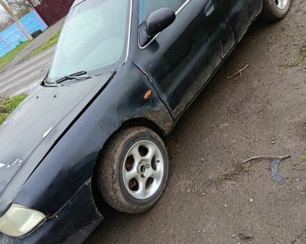 Черный Киа Кларус, объемом двигателя 1.8 л и пробегом 200 тыс. км за 650 $, фото 1 на Automoto.ua