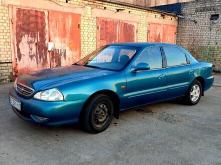 Синій Кіа Кларус, об'ємом двигуна 2 л та пробігом 210 тис. км за 2100 $, фото 1 на Automoto.ua