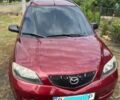 Красный Мазда 2, объемом двигателя 1.4 л и пробегом 240 тыс. км за 3800 $, фото 1 на Automoto.ua