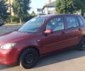 Красный Мазда 2, объемом двигателя 1.4 л и пробегом 305 тыс. км за 3600 $, фото 1 на Automoto.ua