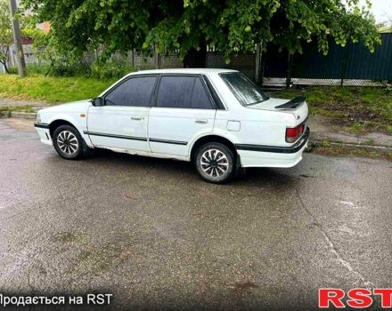 Белый Мазда 323, объемом двигателя 1.5 л и пробегом 326 тыс. км за 700 $, фото 1 на Automoto.ua