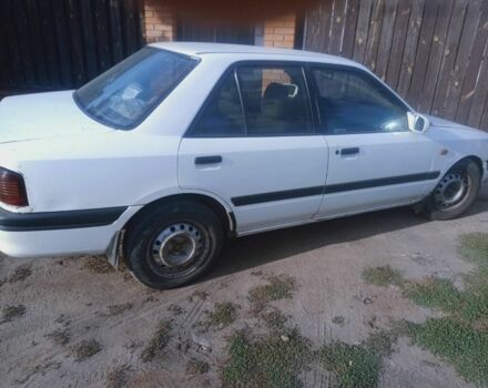 Белый Мазда 323, объемом двигателя 1 л и пробегом 320 тыс. км за 1000 $, фото 1 на Automoto.ua