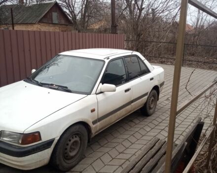 Белый Мазда 323, объемом двигателя 1 л и пробегом 335 тыс. км за 1200 $, фото 1 на Automoto.ua