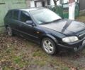Черный Мазда 323, объемом двигателя 1 л и пробегом 260 тыс. км за 450 $, фото 1 на Automoto.ua