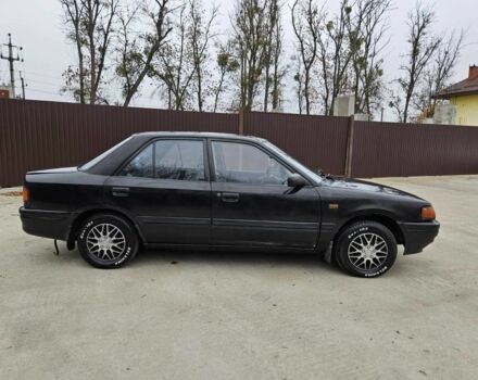 Черный Мазда 323, объемом двигателя 1.5 л и пробегом 400 тыс. км за 1200 $, фото 1 на Automoto.ua