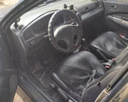 Черный Мазда 323, объемом двигателя 1.49 л и пробегом 319 тыс. км за 2400 $, фото 2 на Automoto.ua