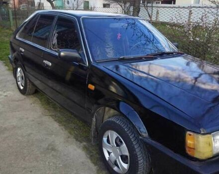 Черный Мазда 323, объемом двигателя 1.5 л и пробегом 249 тыс. км за 750 $, фото 1 на Automoto.ua