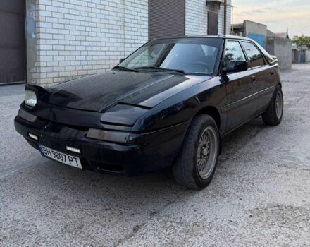 Черный Мазда 323, объемом двигателя 1.8 л и пробегом 300 тыс. км за 1200 $, фото 1 на Automoto.ua