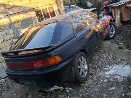 Черный Мазда 323, объемом двигателя 1 л и пробегом 400 тыс. км за 640 $, фото 1 на Automoto.ua