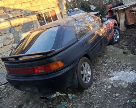 Черный Мазда 323, объемом двигателя 1 л и пробегом 400 тыс. км за 640 $, фото 1 на Automoto.ua