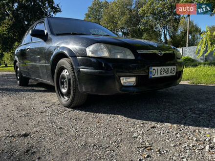 Черный Мазда 323, объемом двигателя 1.6 л и пробегом 200 тыс. км за 2300 $, фото 1 на Automoto.ua