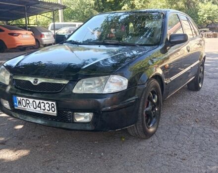 Черный Мазда 323, объемом двигателя 2 л и пробегом 420 тыс. км за 1450 $, фото 1 на Automoto.ua