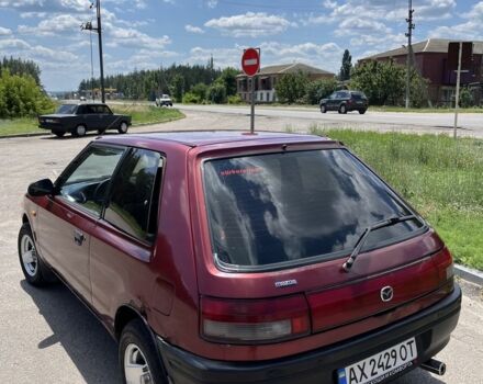 Червоний Мазда 323, об'ємом двигуна 1.3 л та пробігом 400 тис. км за 2000 $, фото 4 на Automoto.ua