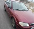 Красный Мазда 323, объемом двигателя 1.5 л и пробегом 285 тыс. км за 2000 $, фото 1 на Automoto.ua