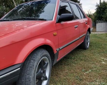 Красный Мазда 323, объемом двигателя 1.5 л и пробегом 260 тыс. км за 1450 $, фото 2 на Automoto.ua