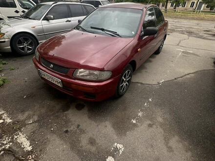 Красный Мазда 323, объемом двигателя 1.5 л и пробегом 295 тыс. км за 2500 $, фото 1 на Automoto.ua