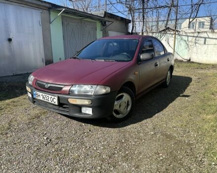 Красный Мазда 323, объемом двигателя 1.5 л и пробегом 282 тыс. км за 1500 $, фото 1 на Automoto.ua