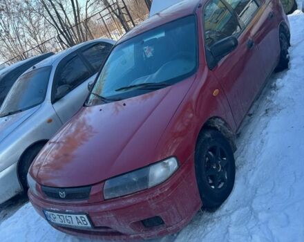 Красный Мазда 323, объемом двигателя 1.5 л и пробегом 250 тыс. км за 1800 $, фото 1 на Automoto.ua