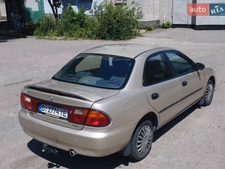 Серый Мазда 323, объемом двигателя 1.5 л и пробегом 390 тыс. км за 2500 $, фото 1 на Automoto.ua