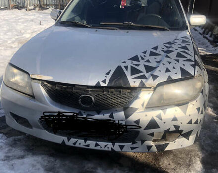 Серый Мазда 323, объемом двигателя 2 л и пробегом 250 тыс. км за 1000 $, фото 1 на Automoto.ua