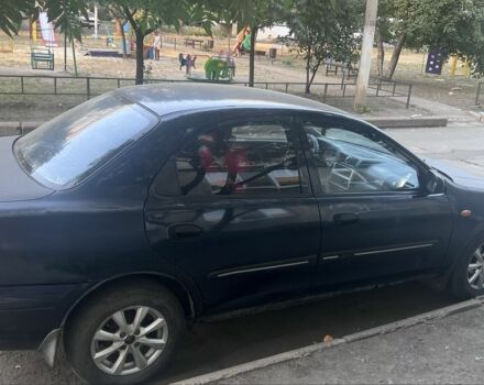 Синій Мазда 323, об'ємом двигуна 1.5 л та пробігом 300 тис. км за 2000 $, фото 2 на Automoto.ua