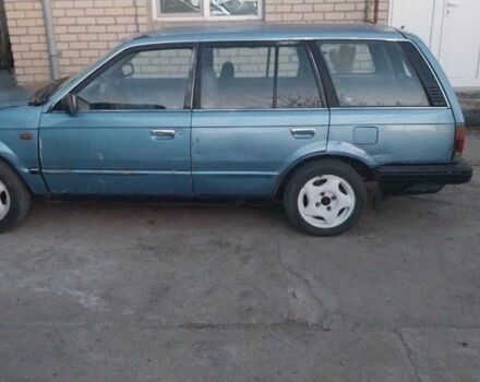 Синий Мазда 323, объемом двигателя 2 л и пробегом 300 тыс. км за 1100 $, фото 1 на Automoto.ua