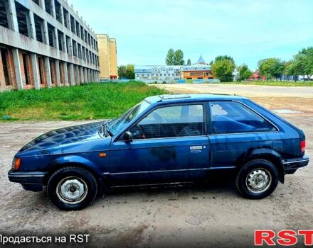 Синий Мазда 323, объемом двигателя 1.5 л и пробегом 254 тыс. км за 530 $, фото 1 на Automoto.ua