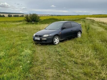 Синий Мазда 323, объемом двигателя 1.5 л и пробегом 325 тыс. км за 1050 $, фото 1 на Automoto.ua