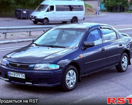 Синий Мазда 323, объемом двигателя 1.5 л и пробегом 300 тыс. км за 1500 $, фото 1 на Automoto.ua