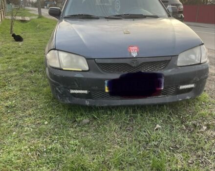 Синий Мазда 323, объемом двигателя 2 л и пробегом 300 тыс. км за 1100 $, фото 1 на Automoto.ua