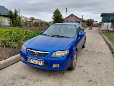 Синий Мазда 323, объемом двигателя 2 л и пробегом 300 тыс. км за 750 $, фото 1 на Automoto.ua