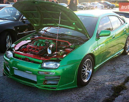 Зеленый Мазда 323, объемом двигателя 2 л и пробегом 200 тыс. км за 4200 $, фото 1 на Automoto.ua