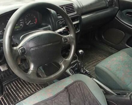 Зелений Мазда 323, об'ємом двигуна 1.49 л та пробігом 350 тис. км за 2100 $, фото 11 на Automoto.ua