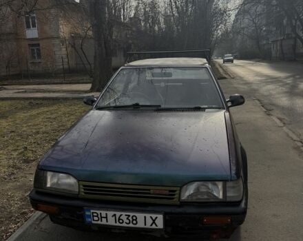 Зеленый Мазда 323, объемом двигателя 1.3 л и пробегом 176 тыс. км за 750 $, фото 1 на Automoto.ua