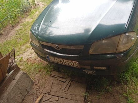 Зеленый Мазда 323, объемом двигателя 2 л и пробегом 415 тыс. км за 560 $, фото 1 на Automoto.ua