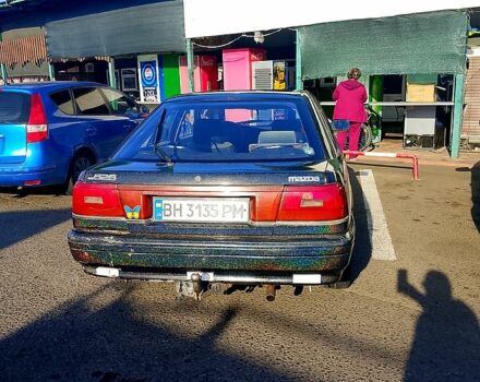 Черный Мазда 626, объемом двигателя 2 л и пробегом 300 тыс. км за 1100 $, фото 1 на Automoto.ua