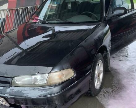 Черный Мазда 626, объемом двигателя 2 л и пробегом 345 тыс. км за 1100 $, фото 1 на Automoto.ua