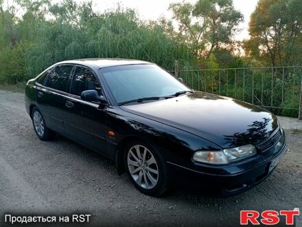 Черный Мазда 626, объемом двигателя 1.8 л и пробегом 333 тыс. км за 1800 $, фото 1 на Automoto.ua