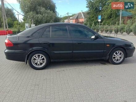 Черный Мазда 626, объемом двигателя 1.8 л и пробегом 316 тыс. км за 2700 $, фото 1 на Automoto.ua